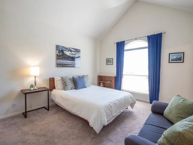 a bedroom with a bed and a couch