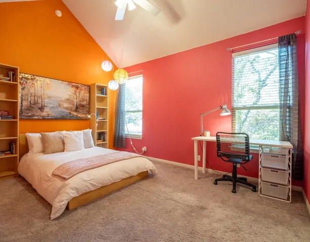 a bedroom with a bed and a window