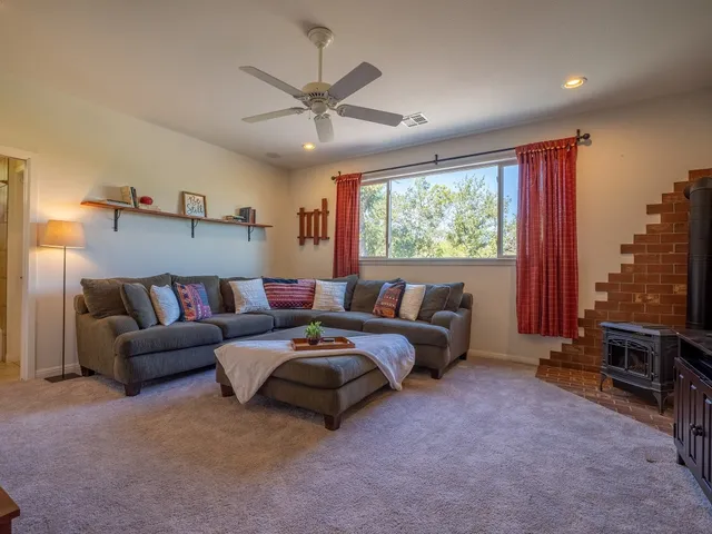 a living room with furniture a window and a flat screen tv