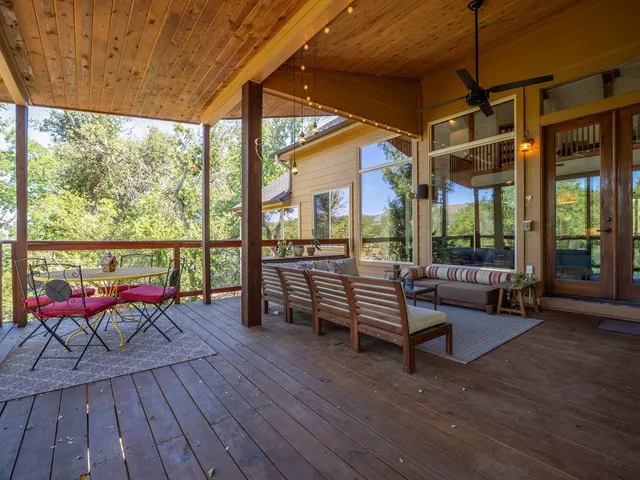 a balcony with wooden floor and furniture
