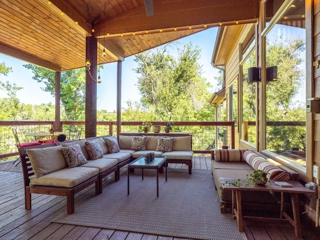 a balcony with furniture and a potted plant