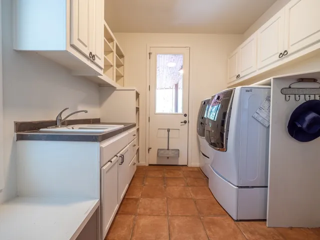 a kitchen with a sink a refrigerator and washer