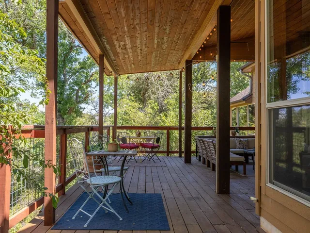a balcony with chairs and wooden floor
