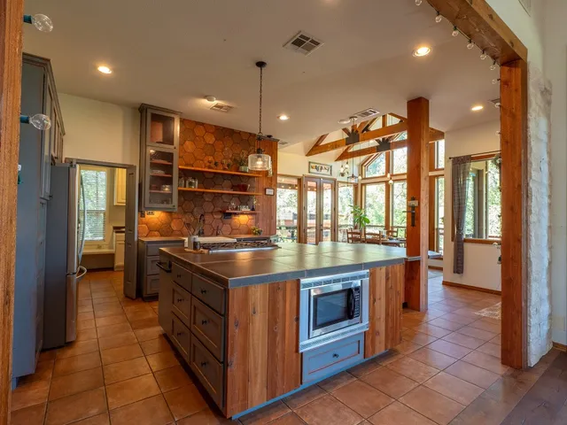 a kitchen with stainless steel appliances granite countertop a stove and a refrigerator