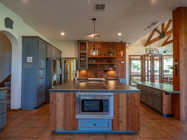 a kitchen with stainless steel appliances granite countertop a stove and a refrigerator