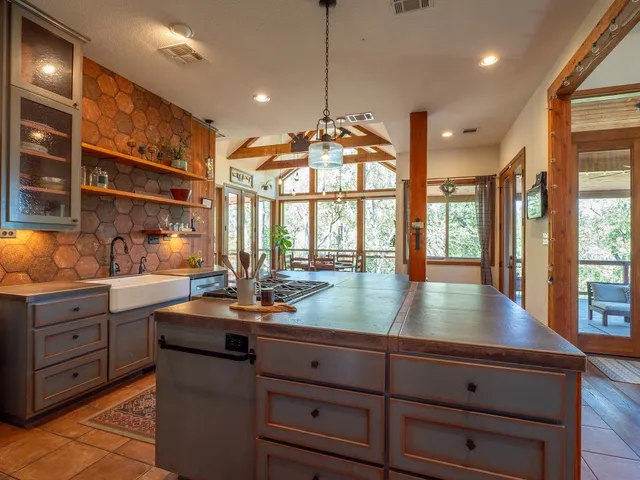a kitchen with stainless steel appliances granite countertop a stove a sink and a refrigerator