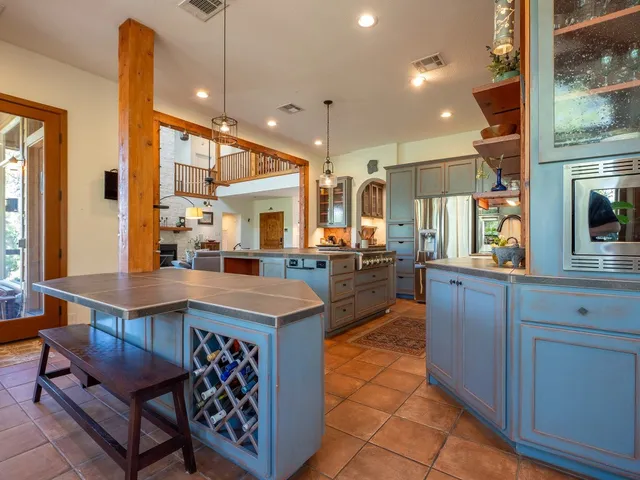a kitchen with stainless steel appliances granite countertop a sink counter space and a window