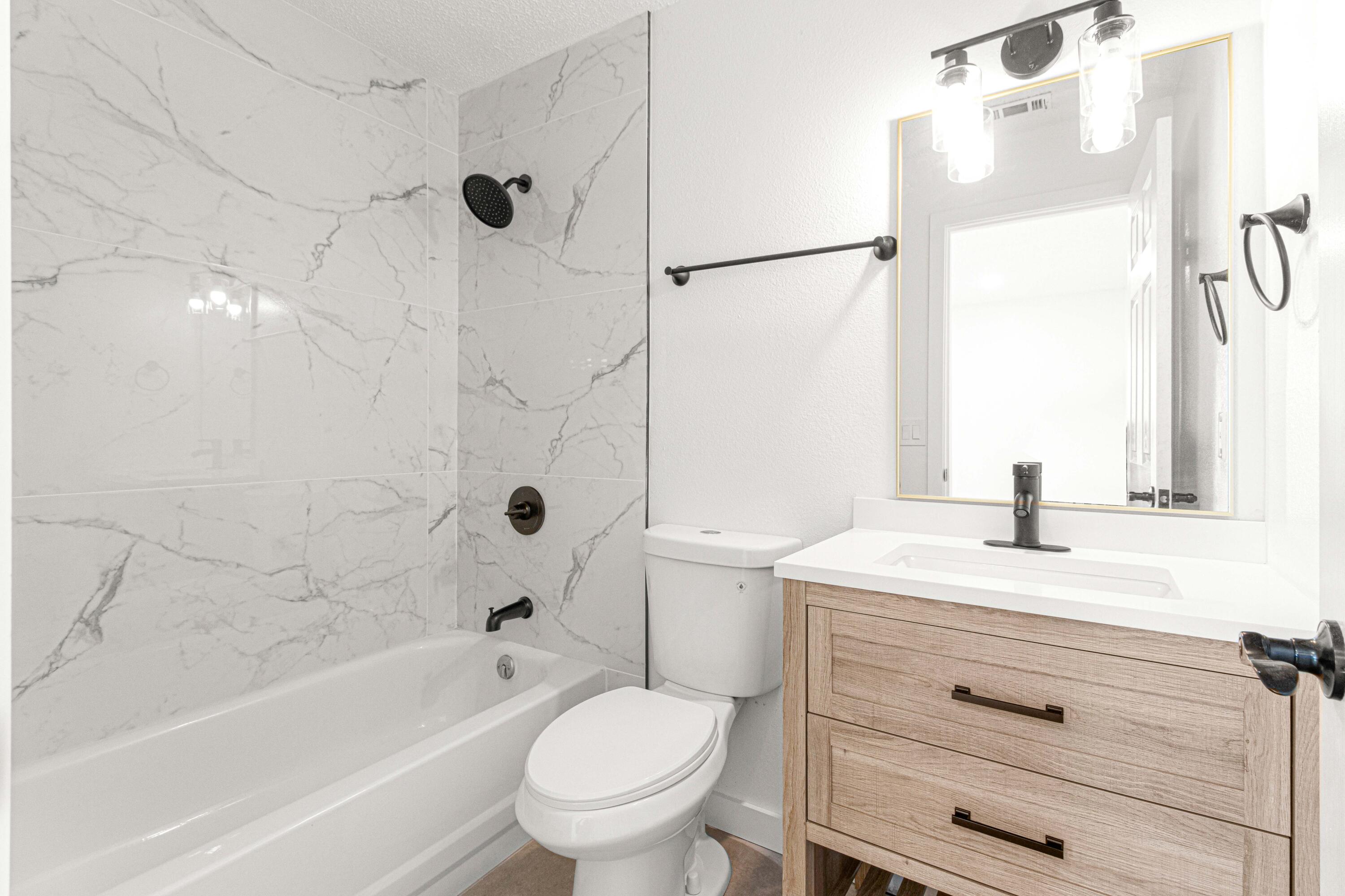 5320 Southeast 28th Lane Ocala, FL 34480 - Photo 8 of 21 a bathroom with a sink toilet a mirror and shower