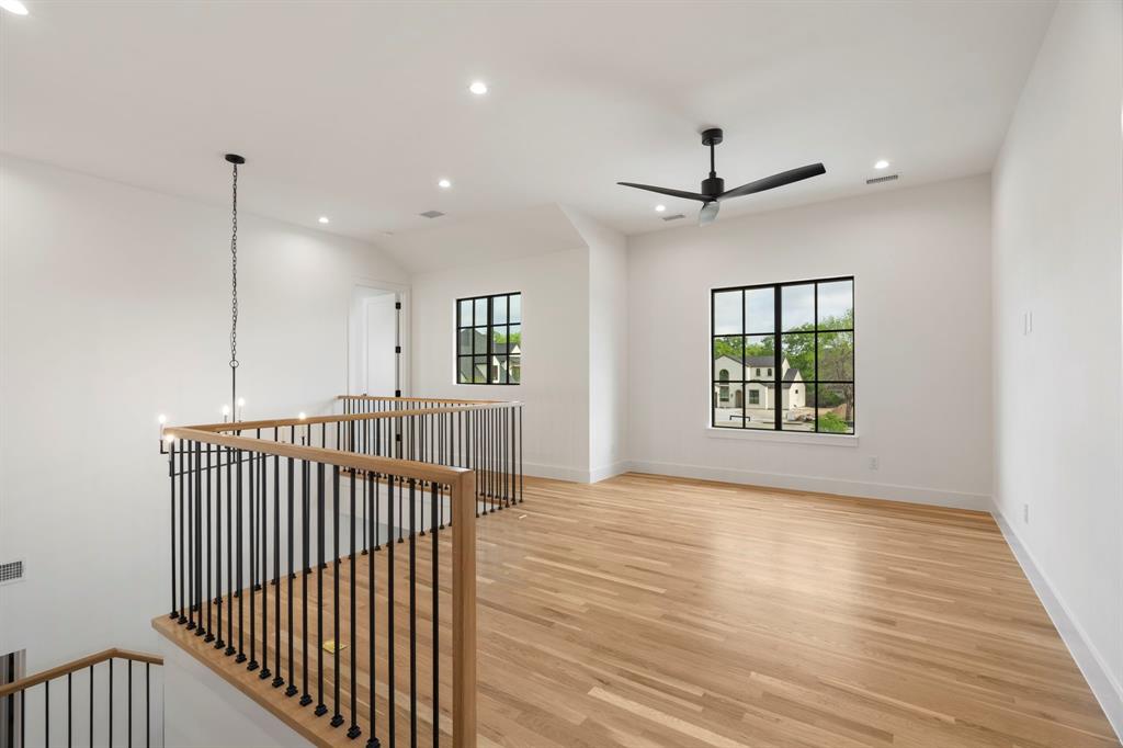 3316 Ferguson Road Grapevine, TX 76092 - Photo 22 of 39 a view of a hallway with wooden floor and a ceiling fan