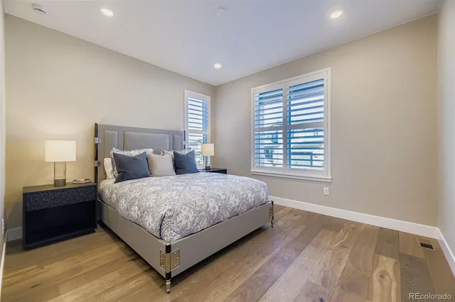 a bed sitting in a bedroom next to a window