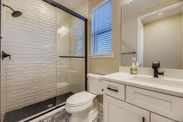 a bathroom with a sink a toilet and mirror