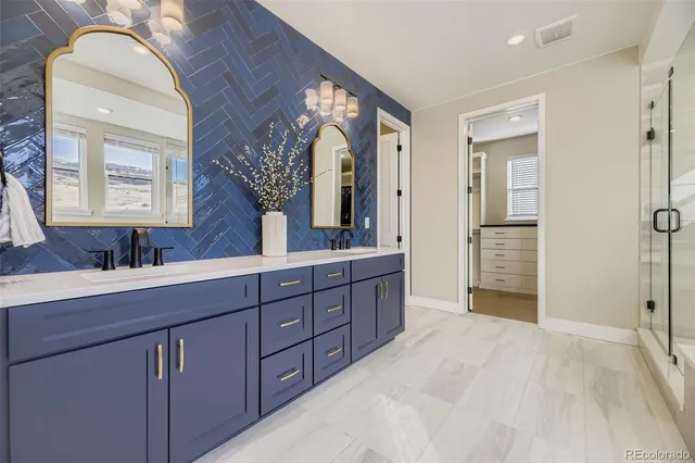 a spacious bathroom with a double vanity sink and a mirror