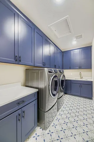 a kitchen with a sink a stove cabinets and utility