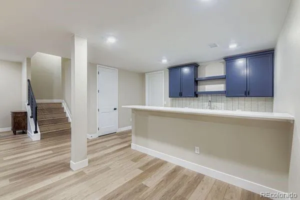 a view of kitchen with cabinets and wooden floor
