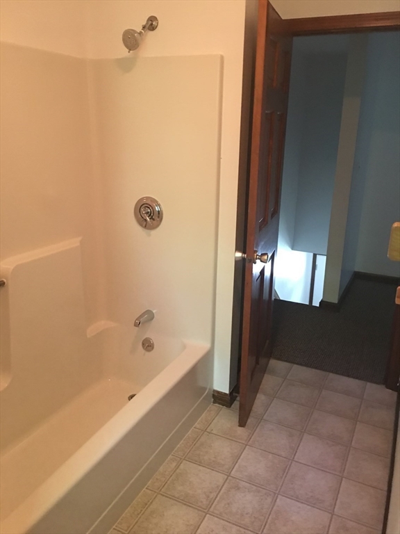 147 East County Road, Unit 147 Rutland, MA 01543 - Photo 11 of 17 a bathroom with a bathtub and shower