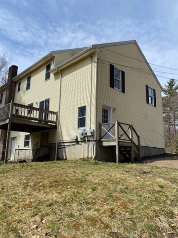 147 East County Road, Unit 147 Rutland, MA 01543 - Photo 2 of 17 a front view of a house with a garden