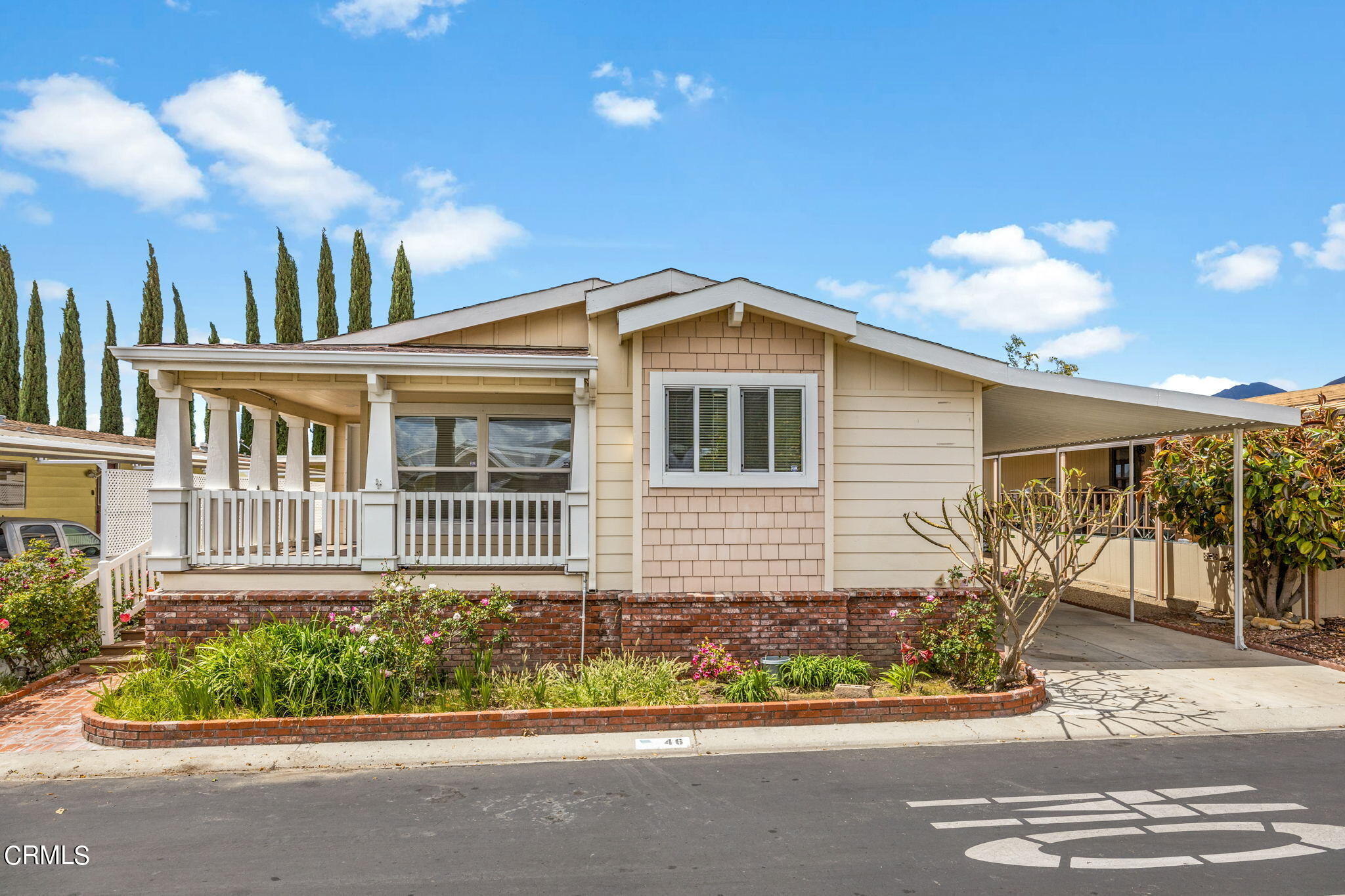 250 East Telegraph Road, Unit 46 Fillmore, CA 93015 - Photo 2 of 32 a front view of a house with a garden