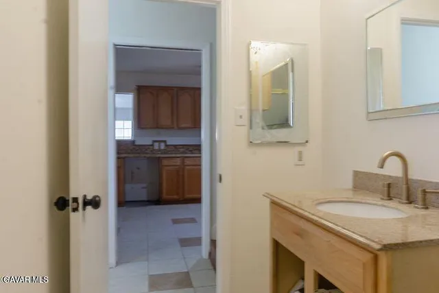 a bathroom with a granite countertop shower and a toilet