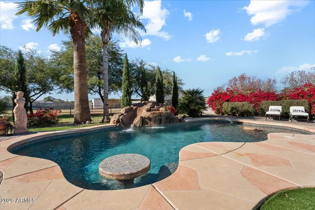 a view of a swimming pool and lounge chairs