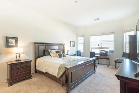 a bedroom with a bed and a couch