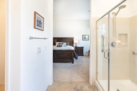 a en suite bathroom with a toilet sink and a mirror