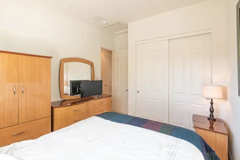 a bedroom with a bed and a flat screen tv