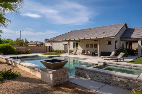 a view of a house with pool and chairs