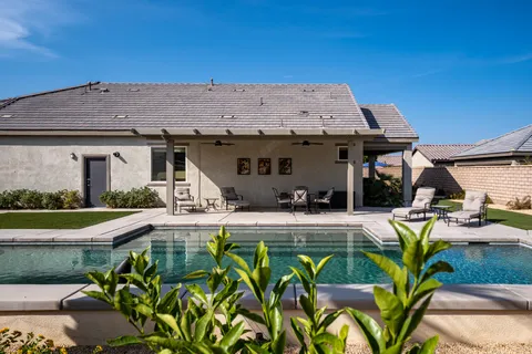 a view of a house with backyard outdoor seating area and furniture