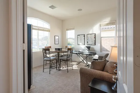 a view of a dining room with furniture and a window