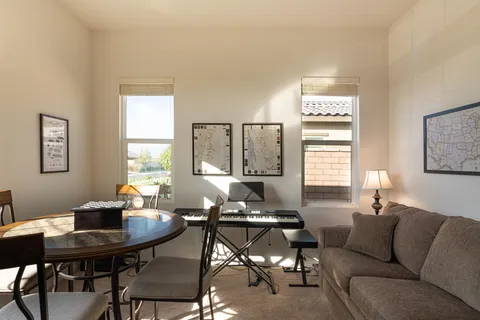 a living room with furniture a window and a table
