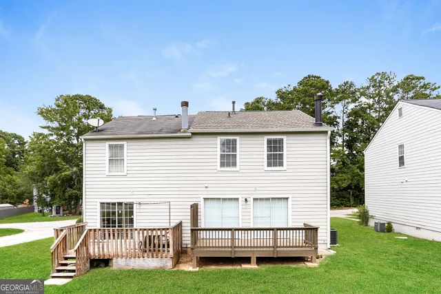a view of a house with a yard and a garden
