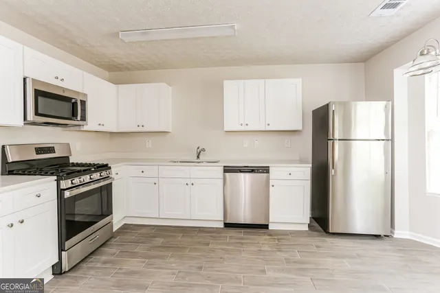 a kitchen with a refrigerator stove and microwave