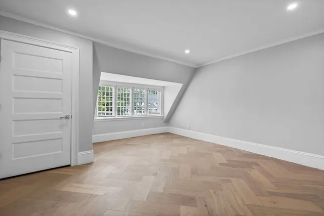 a view of an empty room with a window and fireplace