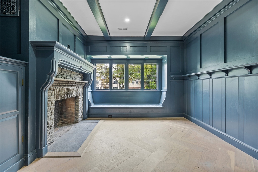 476 Heath Street Brookline, MA 02467 - Photo 2 of 41 a view of an empty room with a fireplace and a window