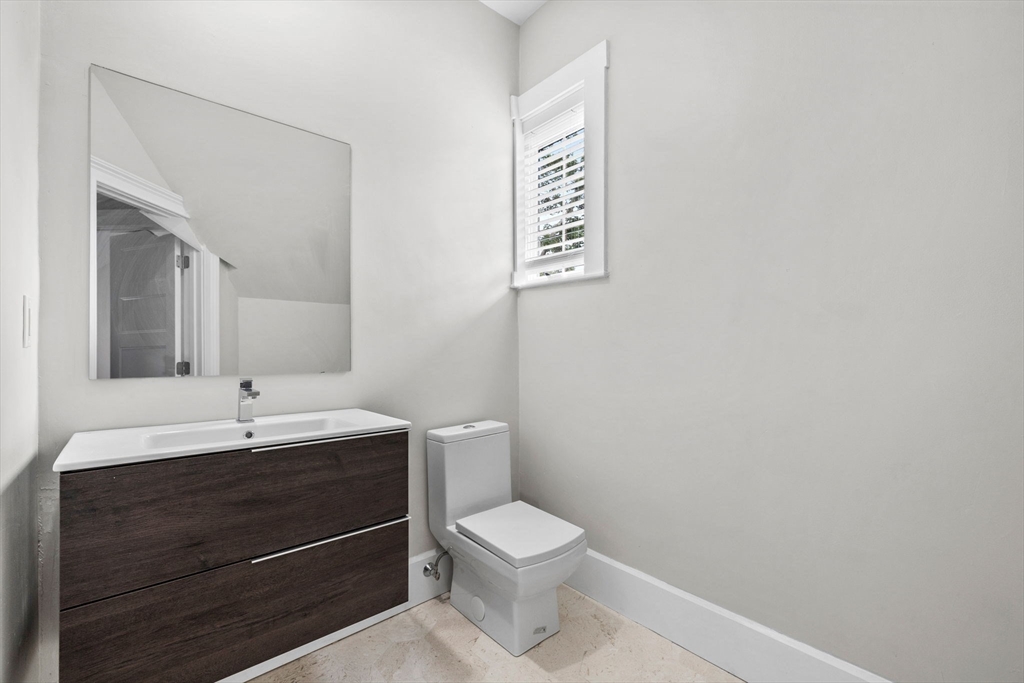 476 Heath Street Brookline, MA 02467 - Photo 25 of 41 a bathroom with a toilet sink and mirror