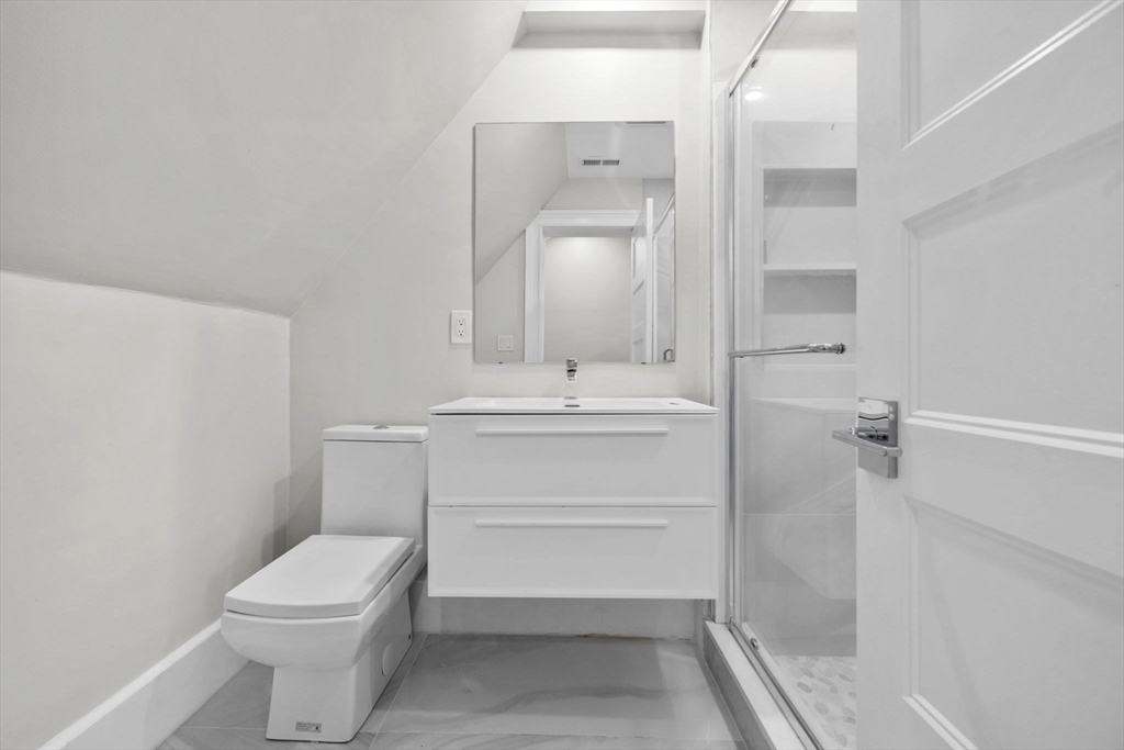 476 Heath Street Brookline, MA 02467 - Photo 28 of 41 a bathroom with a sink mirror vanity and toilet