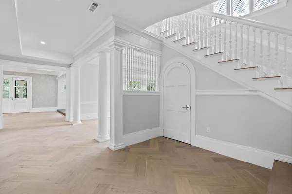 an empty room with staircase and white walls