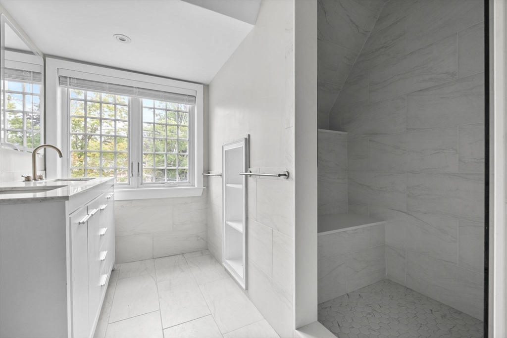 476 Heath Street Brookline, MA 02467 - Photo 34 of 41 a bathroom with a granite countertop sink a toilet and shower