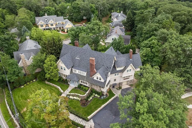 an aerial view of multiple houses with yard