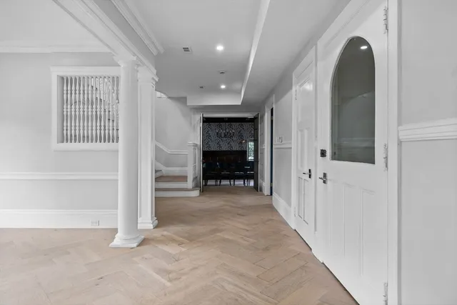 a view of a hallway with wooden shelves and entryway