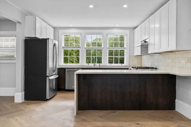 a kitchen with a refrigerator and a sink