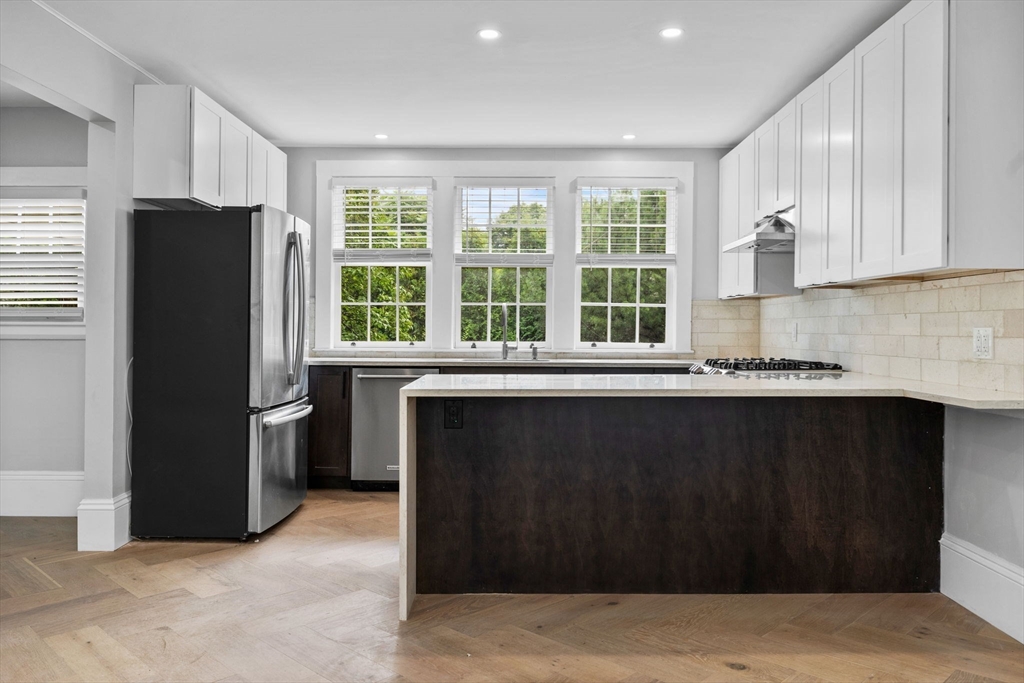 476 Heath Street Brookline, MA 02467 - Photo 10 of 41 a kitchen with a refrigerator and a sink