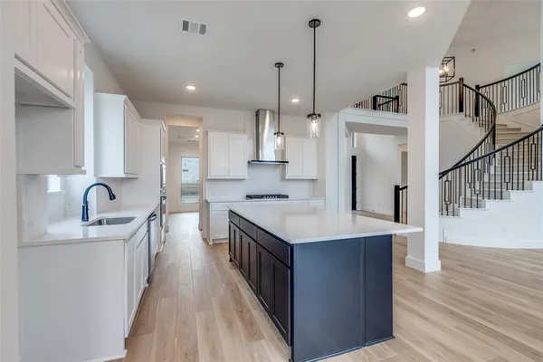 a kitchen with stainless steel appliances granite countertop a sink stove and wooden floor