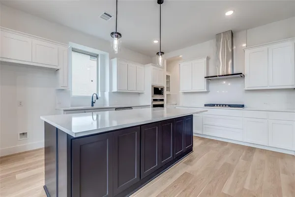 a kitchen with a sink stove and cabinets