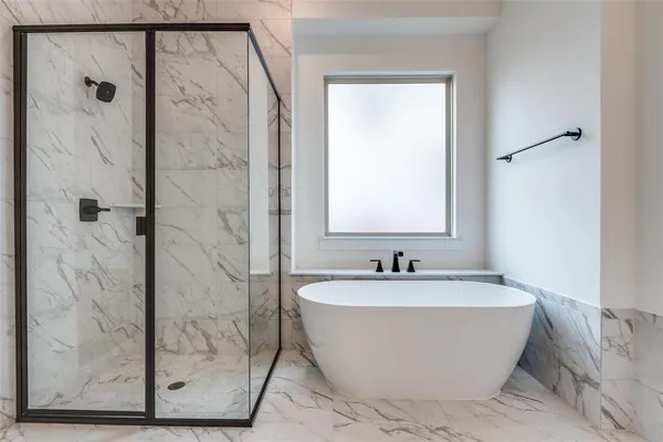 a white bath tub sitting next to a shower