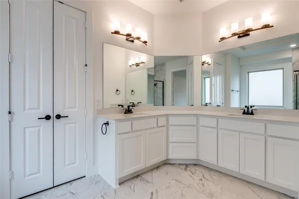 a spacious bathroom with a double vanity sink and a mirror