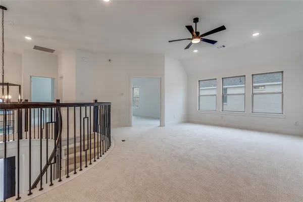 a view of an empty room with a ceiling fan