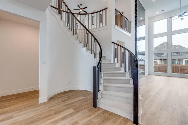 a view of staircase with wooden floor and a front door