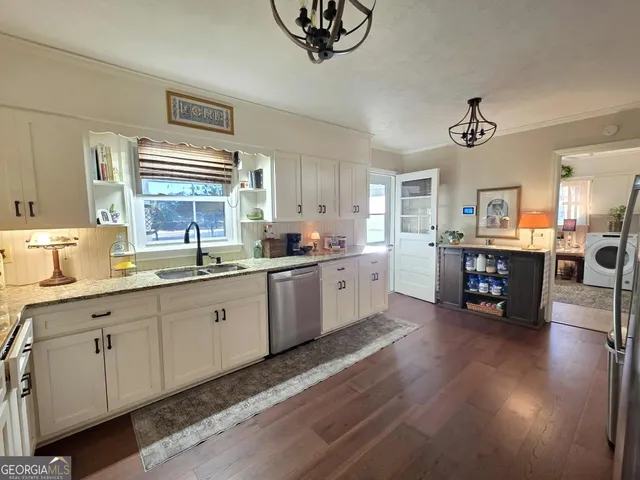 a kitchen with stainless steel appliances granite countertop a stove sink and cabinets