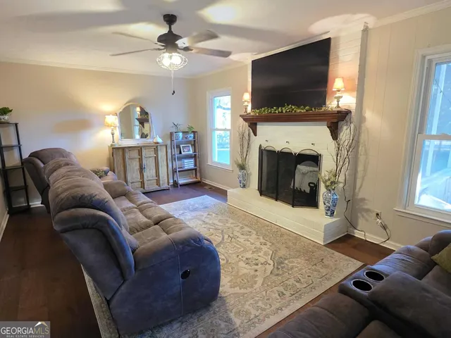 a living room with furniture a flat screen tv and a fireplace